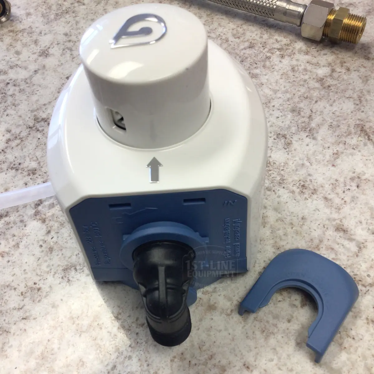 A BWT Bestmax Installation Kit is placed on a marble countertop, featuring a white and blue filter head with a plastic connector, a blue installation clip nearby, and part of a braided metal hose visible in the corner.