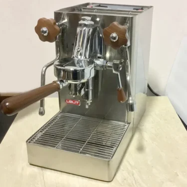 A SOLD SIDEWALK SALE - Lelit Mara X PL62X HX Espresso Machine (used) (E213) with stainless steel finish and wooden accents sits elegantly on a light countertop.