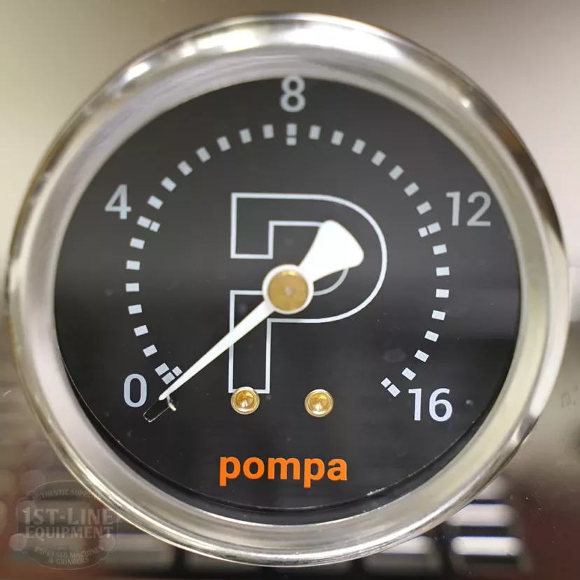 A close-up of a circular pressure gauge on the DISCONTINUED Profitec Pro 700 Dual Boiler Espresso Machine - PID, Switchable shows a black face with white numbers (0–16), pompa in orange, and a large white P at the center; the needle points to zero. © 2025 1st-line.com