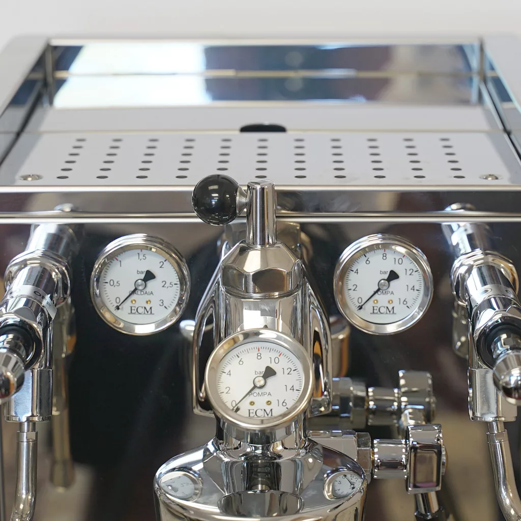 A close-up of the SOLD ECM E61 Grouphead Espresso Machine with Flow Control, featuring three pressure gauges, multiple knobs, levers, and a reflective finish. © 2025 1st-line.com