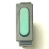 A top-view close-up of the V.4331 YELLOW MOMENTARY PUSH SWITCH, a rectangular black electronic component with a textured, illuminated green oval indicator, displayed on a white background. © 2025 1st-line.com