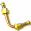 The VBM277 LOWER LEVEL PIPE has two right-angle bends, brass nuts, and threaded connectors at both ends, shown against a white background. © 2025 1st-line.com