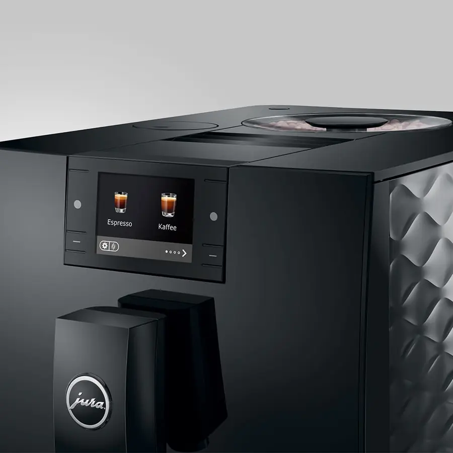 Close-up of the Jura C9 Super-Automatic Espresso Machine, featuring a digital display with espresso and coffee options, a stylish black design with textured side panel, and the Jura logo displayed on the front spout.