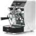 A sleek, modern VBM Junior Digital HX Espresso Machine with a black and white body, chrome accents, steam wand, pressure gauges, Flow Control portafilter, and drip tray featuring the VBM logo on the front.
