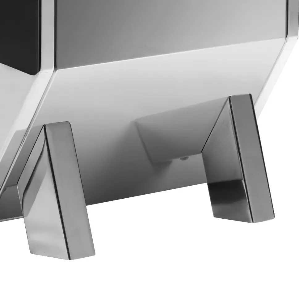 A close-up of the Torre Adele Dual Boiler Espresso Machine reveals its sleek, metallic build and angular legs, with a smooth, shiny surface that reflects light—a modern, minimalist design.
