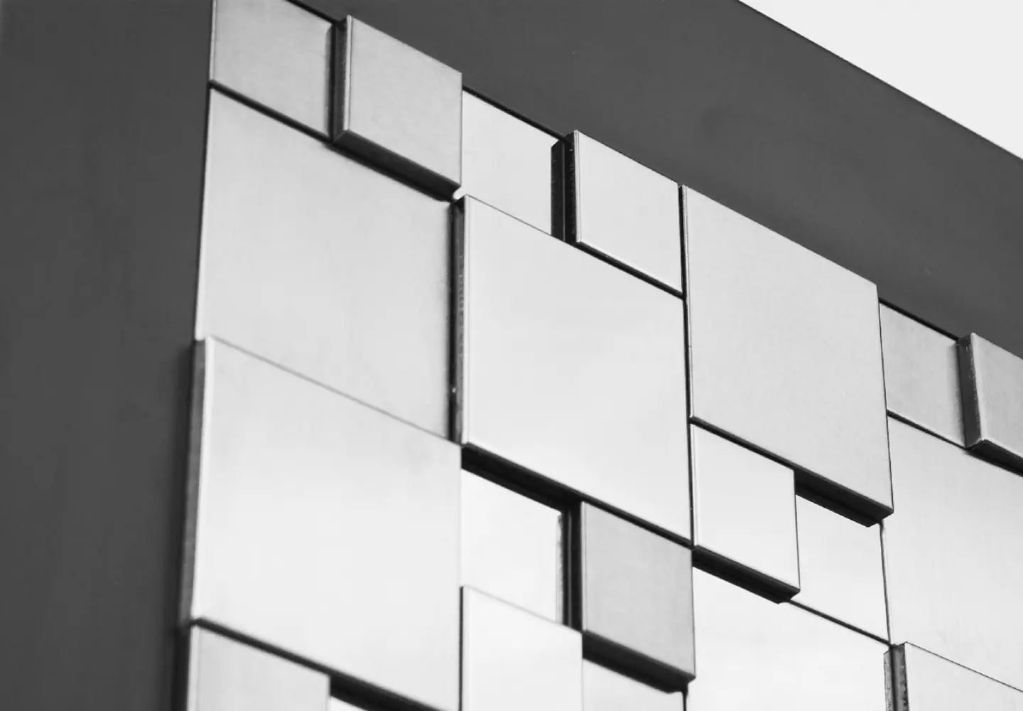 Close-up of the Torre Peppina Luxury Build—a modern wall art piece featuring reflective metallic tiles in a geometric, three-dimensional grid, inspired by sophisticated contemporary design.