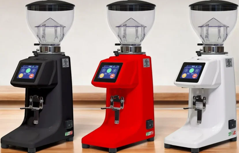 Three Quamar M80TP Espresso Coffee Grinders on a wood tabletop in three different colors black red and white