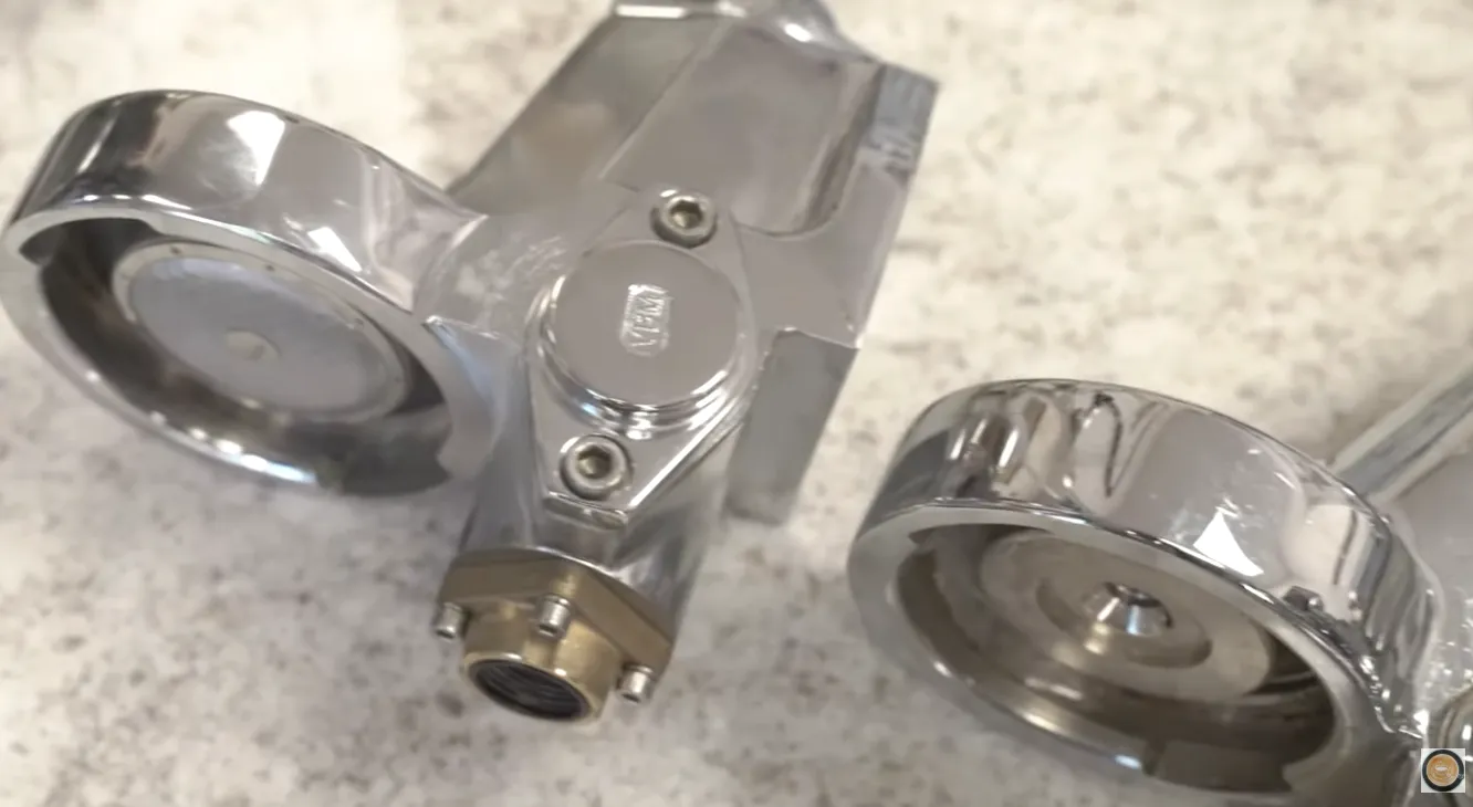 Close up of two E61 Groupheads from espresso machines on a counter