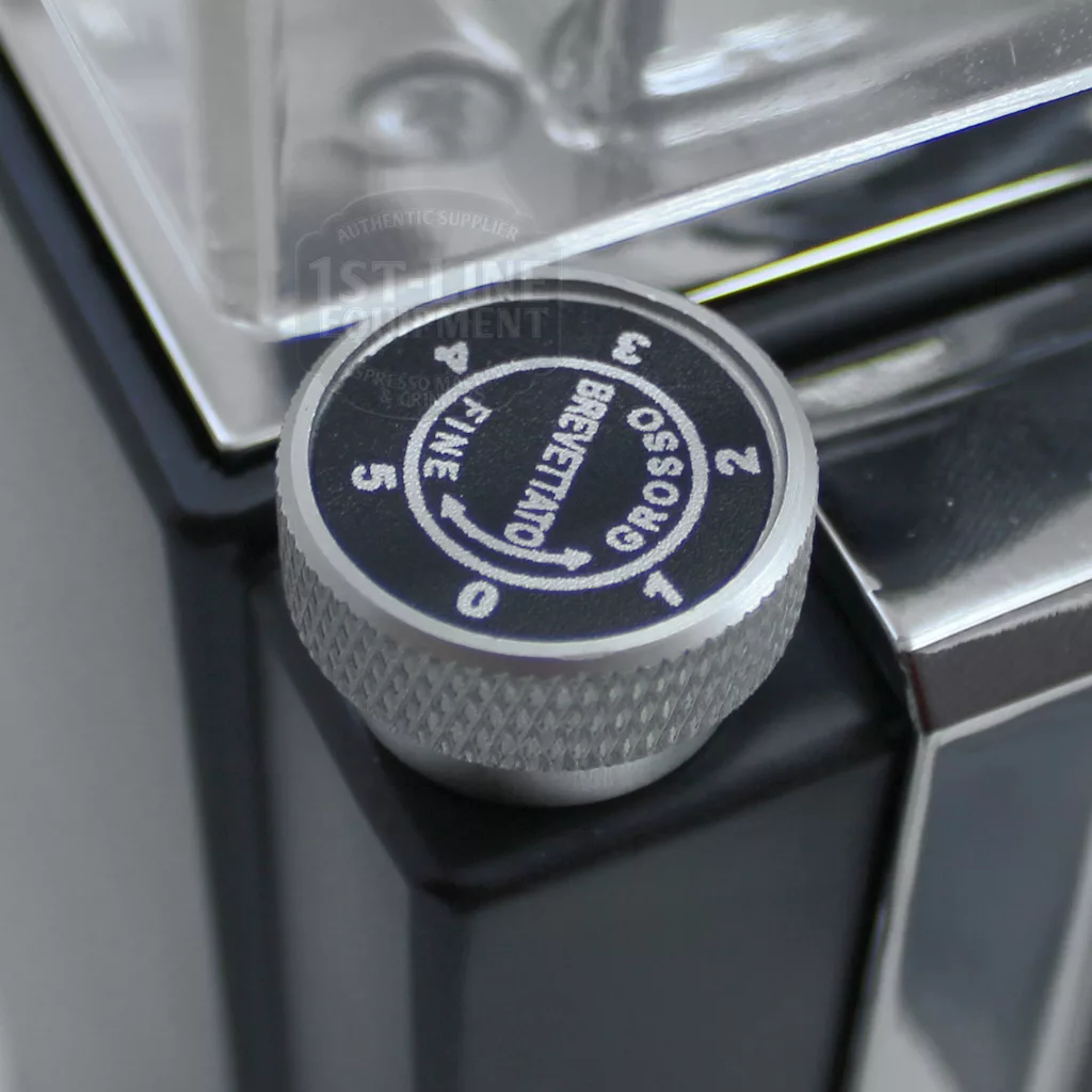A close-up of a silver and black dial labeled 0 to 5 and ROSSO BREVETTATO FINE, attached to a sleek DISCONTINUED Eureka MCI Mignon Programmable Doserless Espresso Coffee Grinder. © 2025 1st-line.com