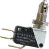 Close-up of the La Nuova Era NE443 Grouphead Lever Microswitch featuring three gold terminals, a black plastic EF83161.1 housing, and a metal plunger actuator with roller—compatible with La Nuova Era espresso machines. © 2025 1st-line.com