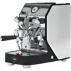 A modern Domobar Super espresso machine with a black and silver design, featuring flow control, multiple dials, levers, and a portafilter on a perforated metal drip tray. The VBM logo is visible on the front.