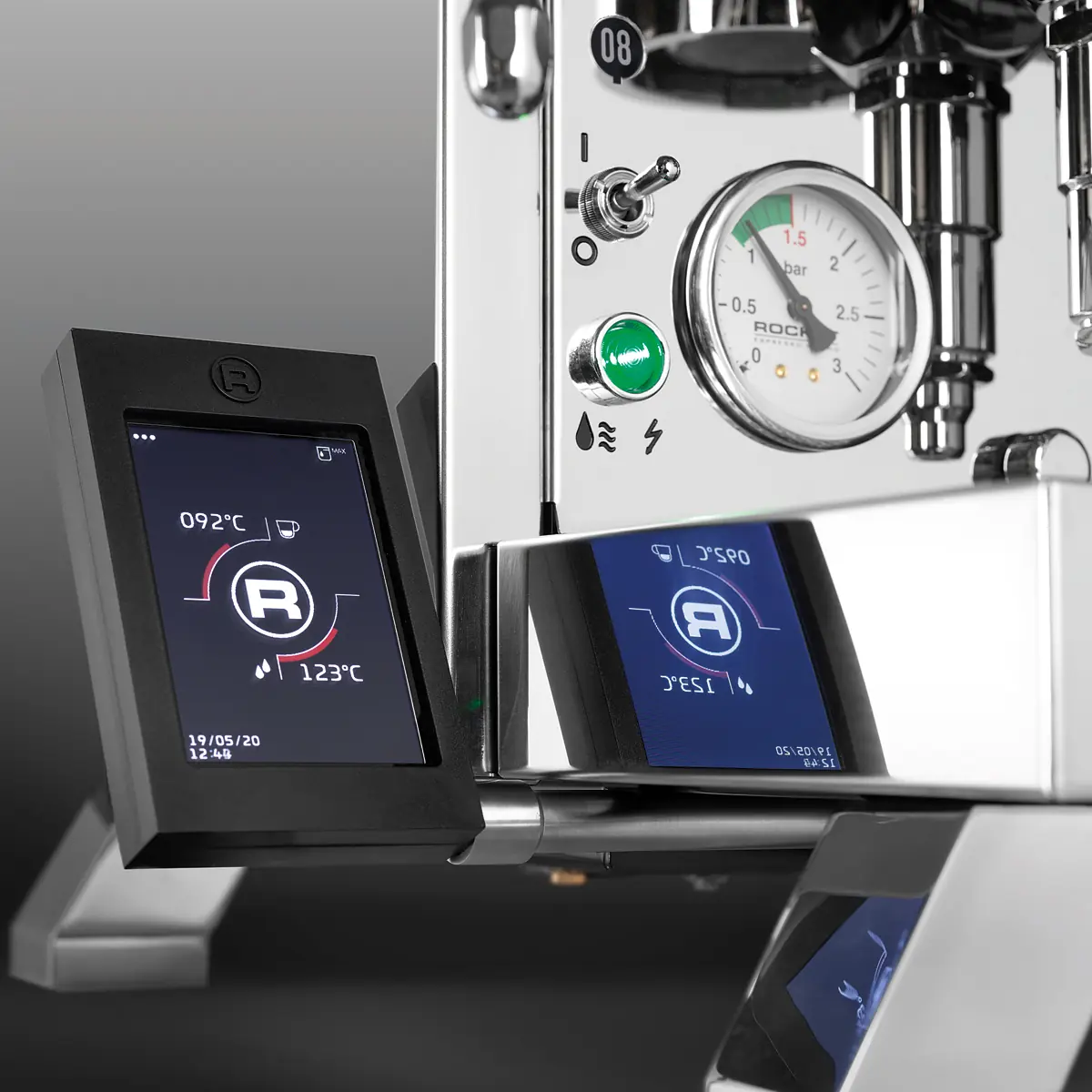 Close-up of the Rocket R Cinquantotto (R58) Dual Boiler Espresso Machine with digital touchscreen display for temperature settings, a pressure gauge, and metal switches and buttons with reflective metallic surfaces.