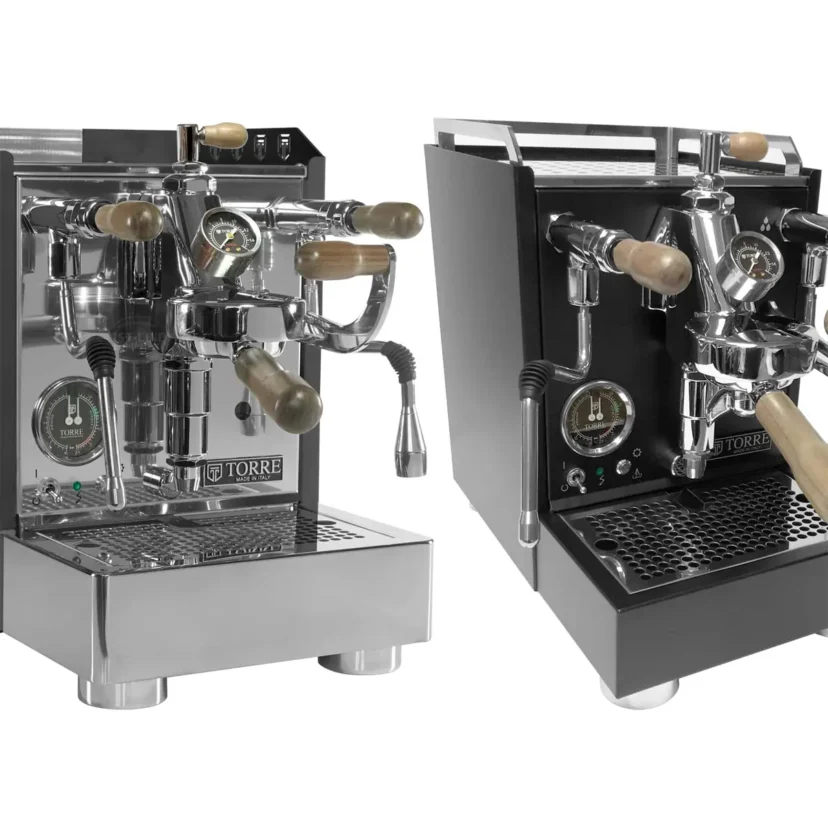 Two espresso machines, the Torre Alfredo TSP HX and Torre Luigino TSP HX, feature wooden handles, metal finishes, pressure gauges, and steam wands. The left is chrome, while the right has a matte black body with chrome accents—highlighting their differences.